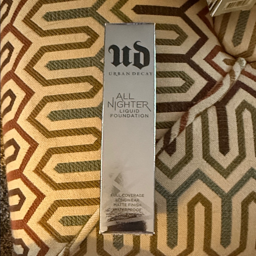 Urban Decay Silver Metallic Foundation Box on Patterned Pillow